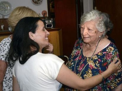 Chicha Mariani (r), a founder of the Grandmothers of Plaza de Mayo, greets a young woman on Thursday who claimed to be her missing granddaughter.