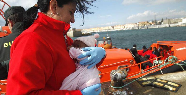 A Red Cross worker with a rescued baby in Tarifa.