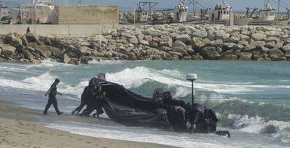 Civil guards push a speedboat used by drug gangs in the Strait of Gibraltar.