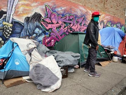 Sotero Cirilo stands near the tent where he sleeps next to other homeless people in the Queens borough of New York on April 14, 2021.