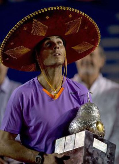Rafael Nadal of Spain wears a traditional Mexican mariachi hat while holding the winning trophy in Acapulco.