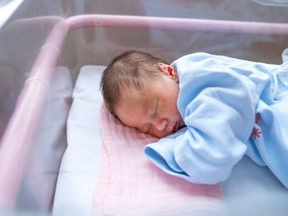 A newborn in his hospital cradle.