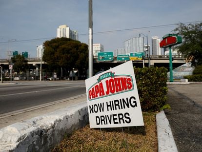 A "Now Hiring" sign advertising jobs at Papa Johns is seen along a street, as the spread of the coronavirus disease (COVID-19) continues, in downtown Miami, Florida, U.S. April 13, 2020.