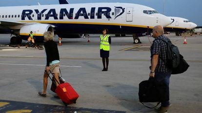 Passengers board a Ryanair flight at London Stansted.