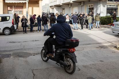 A resident of Campobello di Mazara observes a huddle of journalists and police officers in front of the apartment where Messina Denaro was hiding.