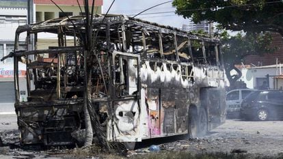 A burned-out bus in the city of Navidad.