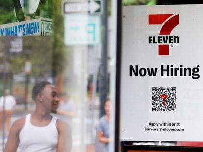 A 7-Eleven convenience store has a sign in the window reading "Now Hiring" in Cambridge, Massachusetts, on July 8, 2022.