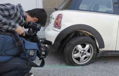 A news camera gets a shot of some of the damage done by the car of Miguel &Aacute;ngel Rodr&iacute;guez.