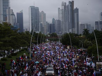 Demonstrators march through the streets of Panama City in the rain on October 26.