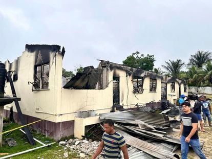 In this photo provided by Guyana's Department of Public Information, the dormitory of a secondary school is burned in Mahdia, Guyana, Monday, May 22, 2023.