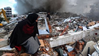  A woman reacts as emergency personnel carry out a search and rescue operation at the site of a collapsed building following an earthquake in Iskenderun, district of Hatay, Turkey.