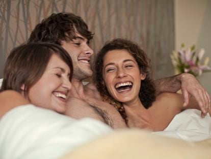Three people in bed together.