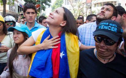 Opposition leader María Corina Machado (center) walks with supporters to a rally in Caracas on Wednesday.