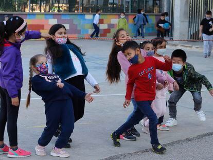 Schoolchildren wearing masks play at a school in Barcelona late last month.