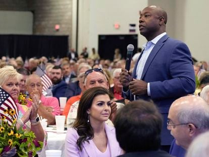 Republican presidential candidate Sen. Tim Scott, R-S.C., right, walks by Casey DeSantis, wife of GOP rival and Florida Gov. Ron DeSantis, center, as he speaks at Rep. Jeff Duncan's Faith & Freedom BBQ fundraiser, Aug. 28, 2023, in Anderson, S.C.
