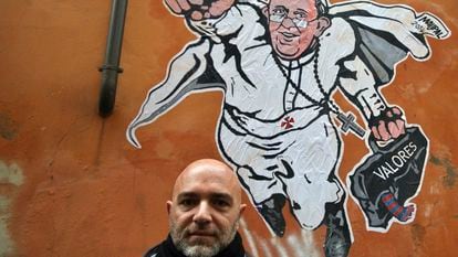 Italian artist Mauro Pallotta poses in front of his graffiti depicting Pope Francis as Superman and holding a bag with a writing which reads: 'Values' near St. Peter's Square in Rome, Jan. 29, 2014.