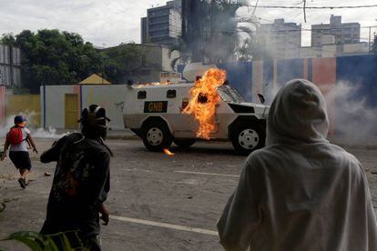An armored police vehicle is hit by petrol bombs thrown by opposition supporters on Wednesday.