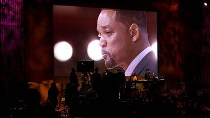 A tearful Will Smith is seen on a screen as he accepts his award for Best Actor.