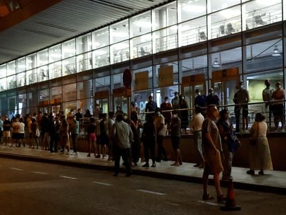 People wait in line to get vaccinated at the Wizink Center arena in Madrid.
