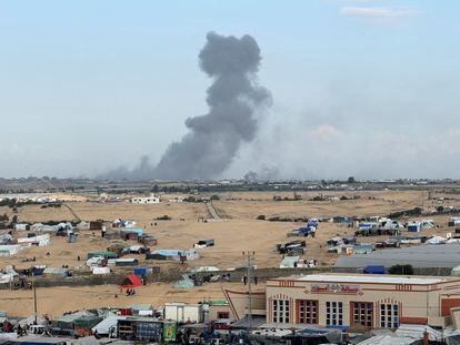 Tents in Rafah, with explosions in the background from Israel's operations.