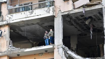 Two men inspect the building hit by a drone strike in a southern Beirut suburb where Hamas number two Saleh al-Arouri was killed on Wednesday.