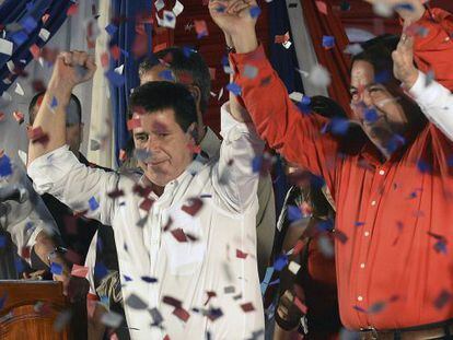 Paraguayan presidential candidate for the Colorado Party, Horacio Cartes (L) and his Vice-President Juan Afara, wave after winning the elections in Asunci&oacute;n.