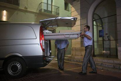 Funeral service workers leave the Dalí Theatre-Museum in Figueres, Spain.