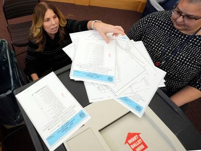 Election workers test the ballot counting machine for the New Hampshire primary at the Derry Municipal Center.