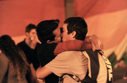 Two gay men kiss on the streets, as Uruguayan Chamber of Deputies approved the "Equal Marriage" law.