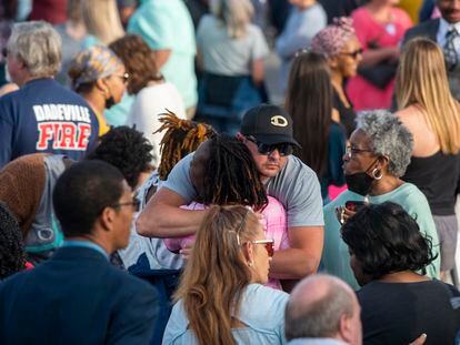 Community members embrace during a prayer vigil at First Baptist Church in Dadeville, Alabama, on April 16, 2023.