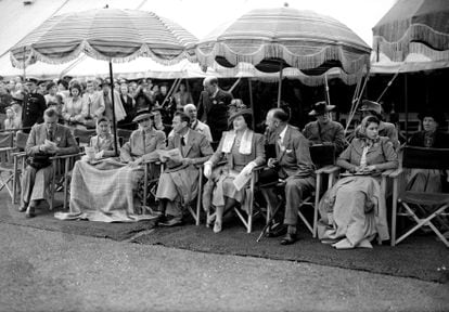26 May 1945: Members of the British Monarch watching an event at the Royal Horse Show at Windsor Home Park, Berkshire (left to right);  Princess Margaret Rose (1930 - 2002), Duchess of Kent, King George VI (1895 - 1952), Queen Elizabeth Queen Consort, Duke of Beaufort and Princess Elizabeth.