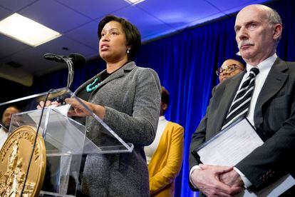 District of Columbia Mayor Muriel Bowser, accompanied by DC Council Chairman Phil Mendelson, right, speaks at a news conference in March 2020 in Washington.
