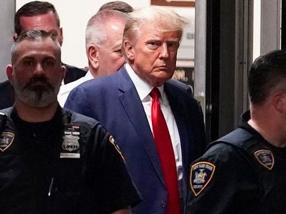 Former President Donald Trump is escorted to a courtroom, April 4, 2023, in New York.
