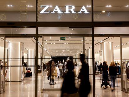 Shoppers walk past a Zara clothes store, part of the Spanish group Inditex, in Las Palmas de Gran Canaria, Spain.