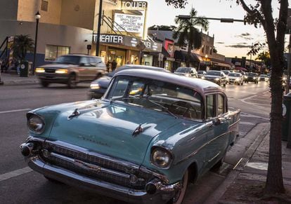 A vintage Chevrolet parked in front of the art nouveau Tower Theater movie house.