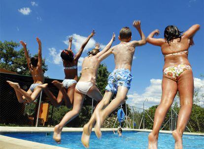 A group of children takes the plunge at a summer camp in Madrid.