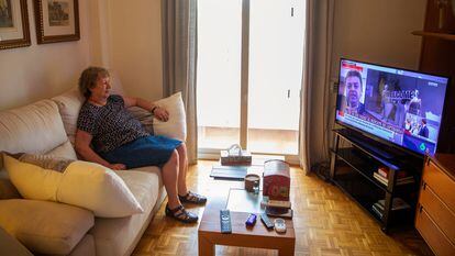 Pilar Orgaz watches television from her home in Madrid. She has only left once to go to a hairdresser.