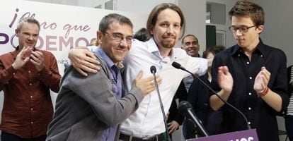 Pablo Iglesias (center) embraces party co-founder Juan Carlos Monedero after learning the results of the European elections in Spain.