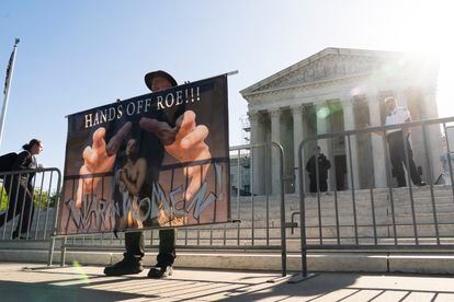 An abortion-rights activist holds a banner outside the U.S. Supreme Court