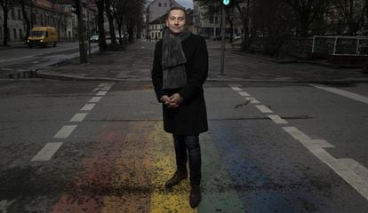 Vladimir Simonko, co-founder of the Lithuanian Gay League (LGL), stands on top of a pride flag painted with the help of volunteers.