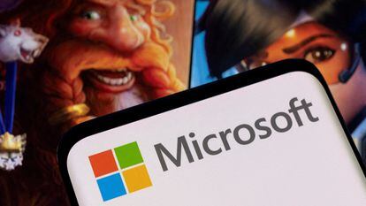 Microsoft logo is seen on a smartphone placed on displayed Activision Blizzard's games characters in this illustration taken January 18, 2022.