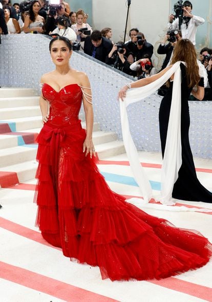 Salma Hayek attends Gala celebrating "Karl Lagerfeld: A Line Of Beauty" wearing with a red Gucci dress.