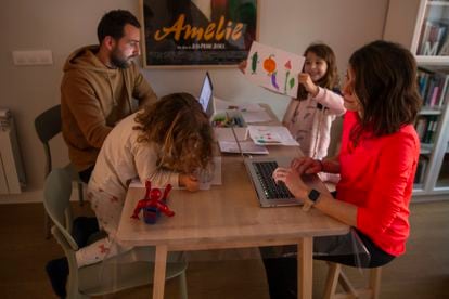Parents working while looking after their children in Madrid.