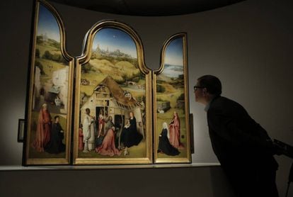 A visitor examines the ‘Adoration of the Magi.’