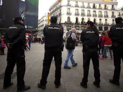 Police officers watching Madrid's central Sol Square on New Year's Eve.