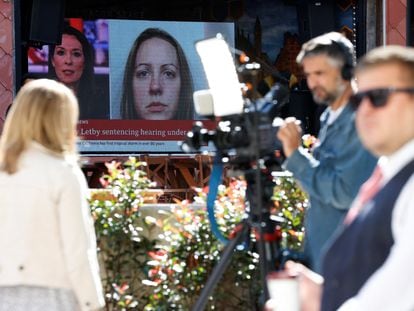 Members of the media work near a large screen showing a picture of convicted hospital nurse Lucy Letby, ahead of her sentencing, outside the Manchester Crown Court, in Manchester, Britain, August 21, 2023.