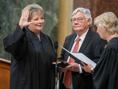 Janet Protasiewicz, left, is sworn as a Wisconsin Supreme Court justice by Supreme Court Justice Ann Walsh Bradley, Tuesday, Aug. 1, 2023, in Madison, Wis. At center is Protasiewicz' husband Greg Sell.
