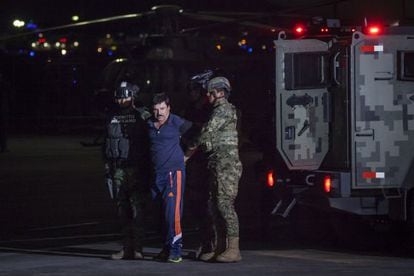 Two soldiers escort “El Chapo” Guzmán.