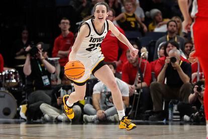 Iowa guard Caitlin Clark smiles after catching her 10th rebound to give her a triple-double against Ohio State in the second half of an NCAA college basketball championship game at the Big Ten women's tournament Sunday.