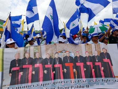 Anti-government demonstrators hold a banner featuring a group of Catholic cardinals during a march supporting the Catholic Church, in Managua, Nicaragua, in July 2018.